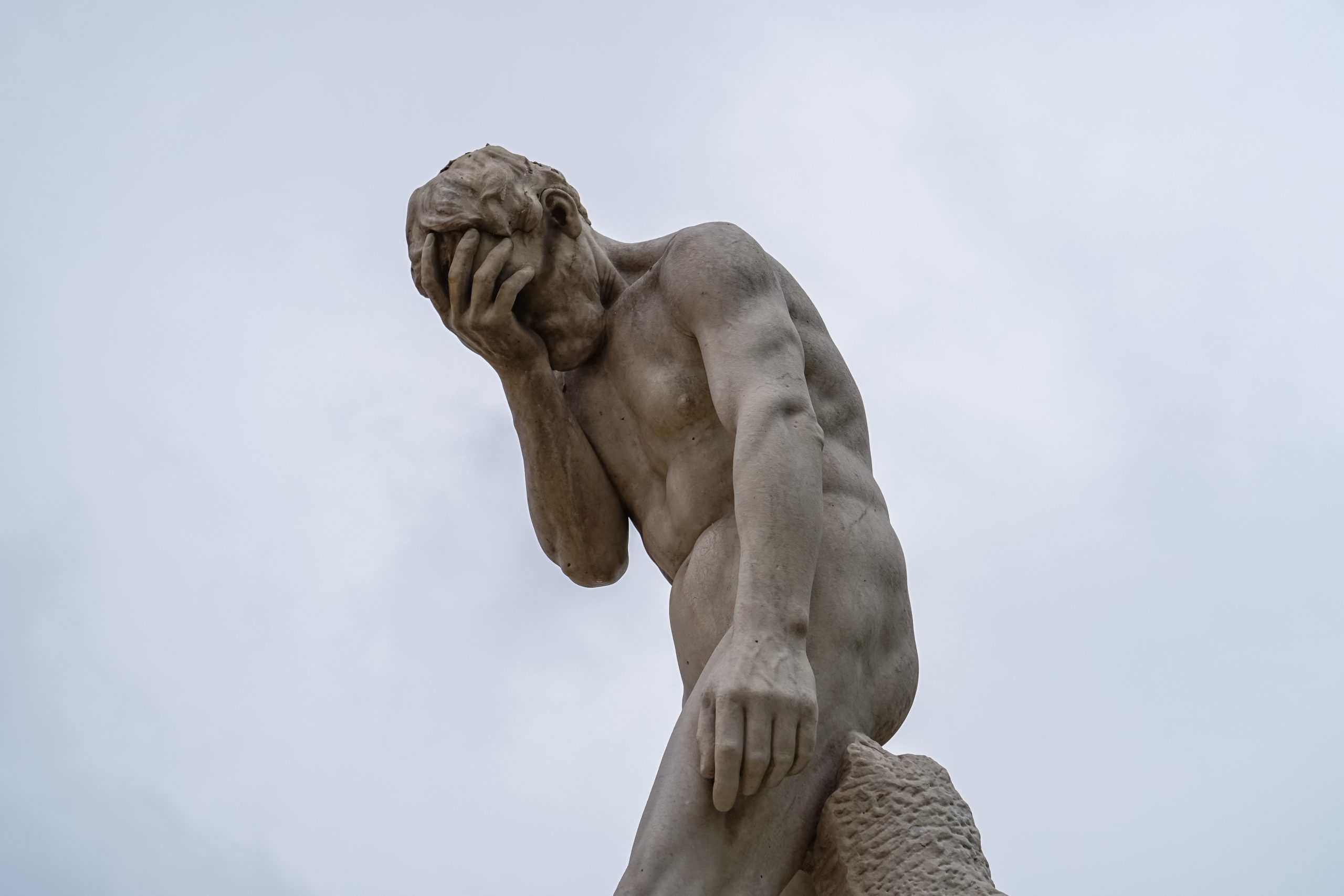A statue doing the facepalm gesture