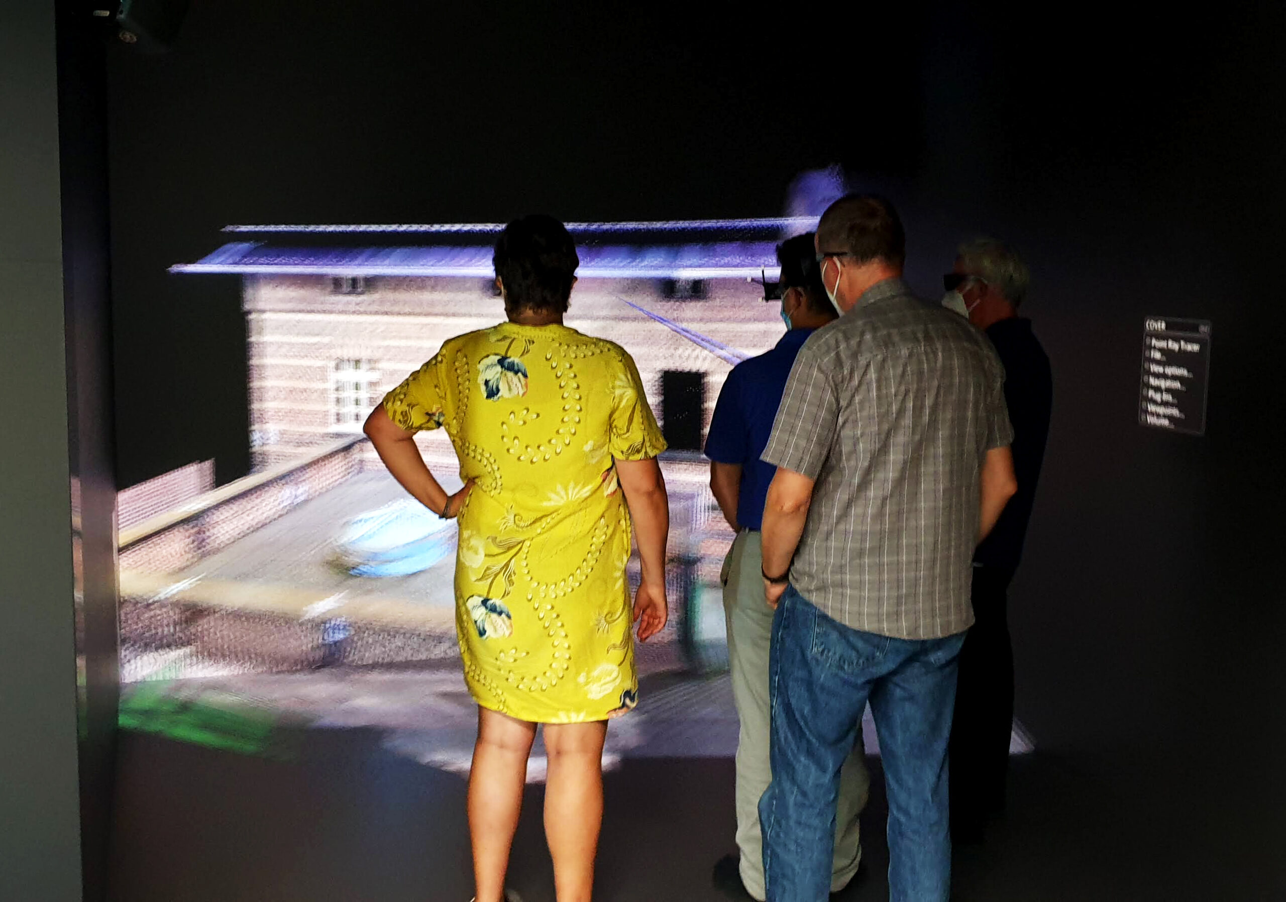 Photo of people using the CAVE, a virtual environment