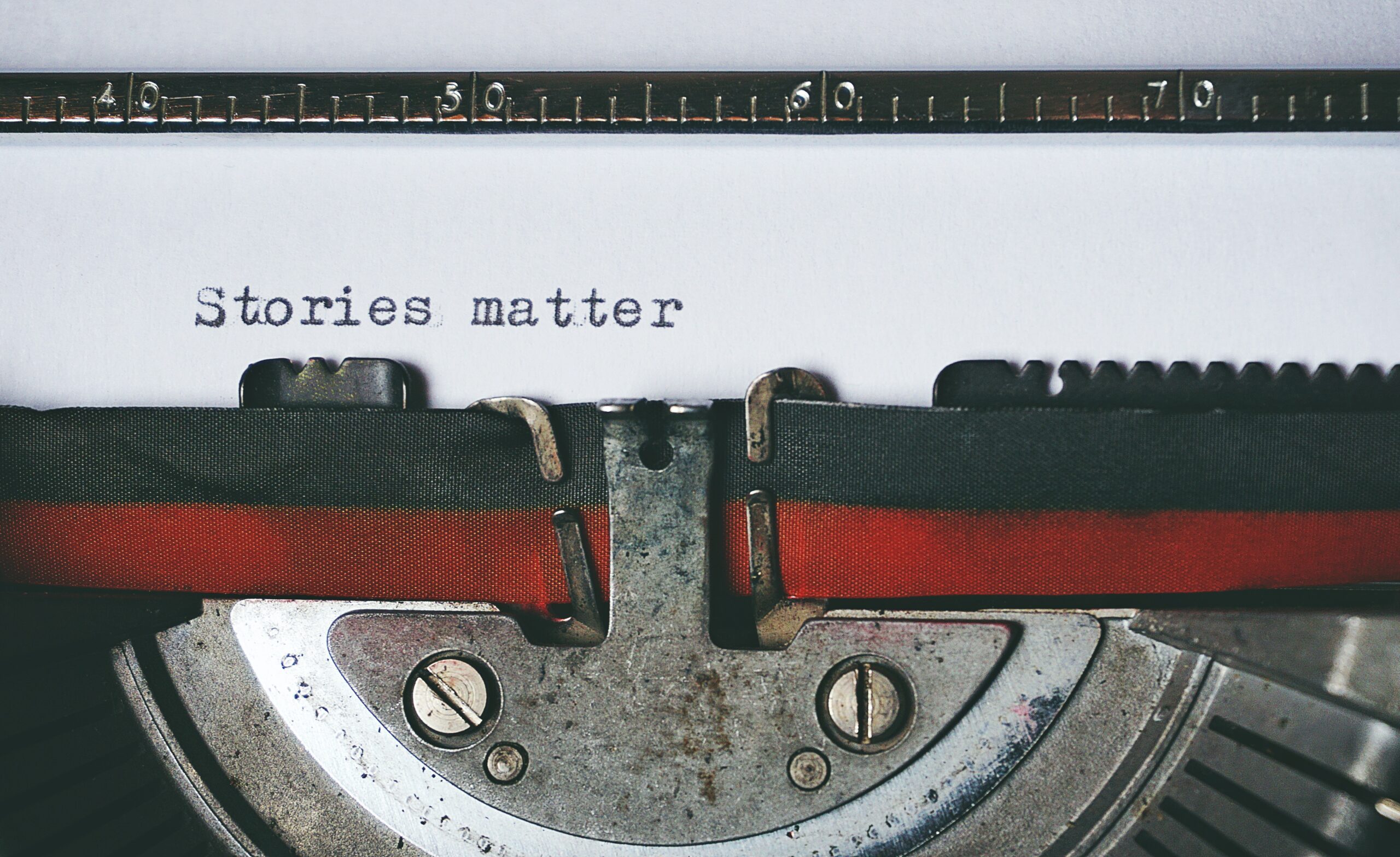 A typewriter spelling out the words "Stories matter". Photo by Suzy Hazelwood