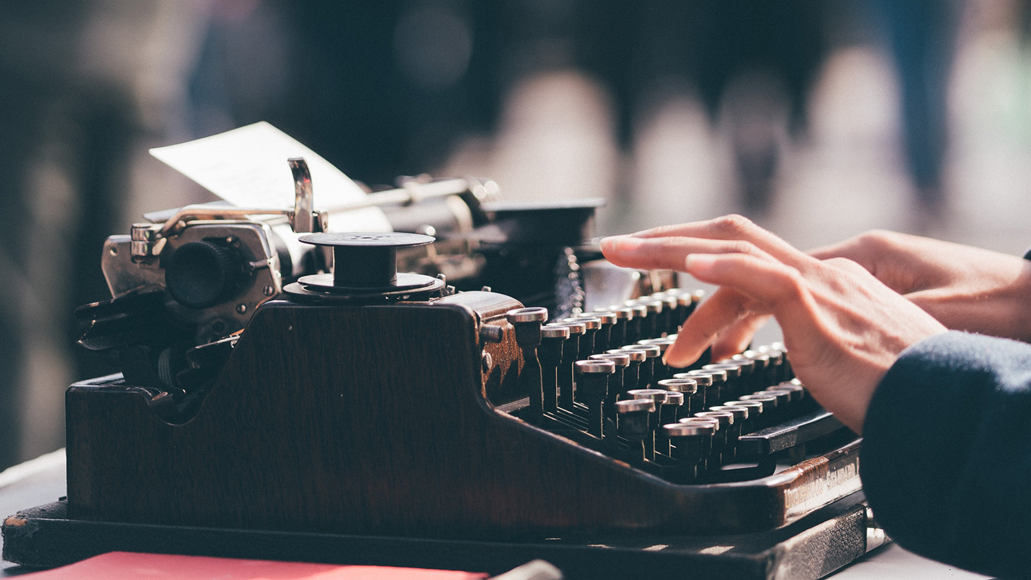 Someone typing on a typwriter, symbolising that we want to write a book. Photo by Thom Milkovic on Unsplash.