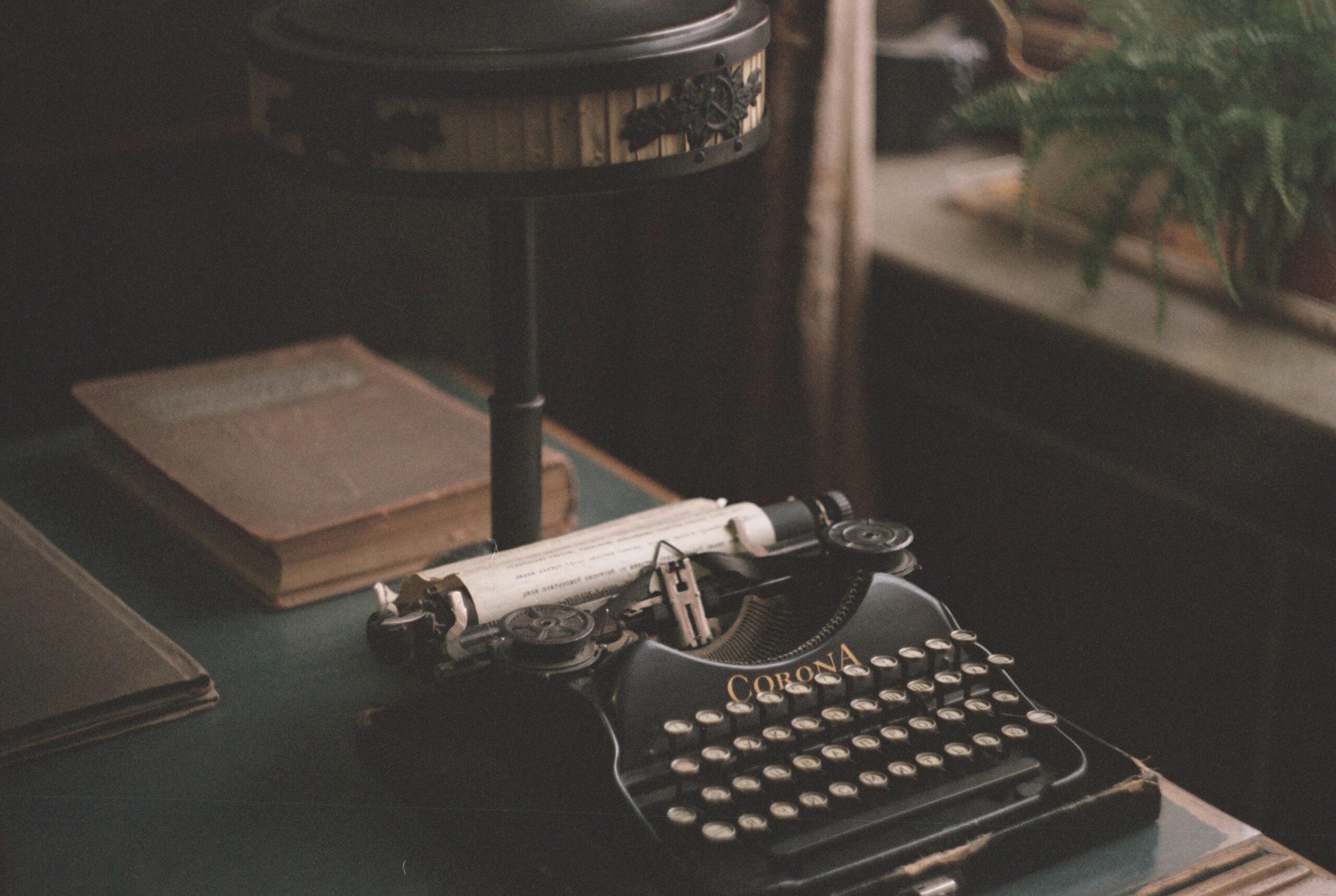 A typewriter on an old desk. Photo by Daria Kraplak on Unsplash.