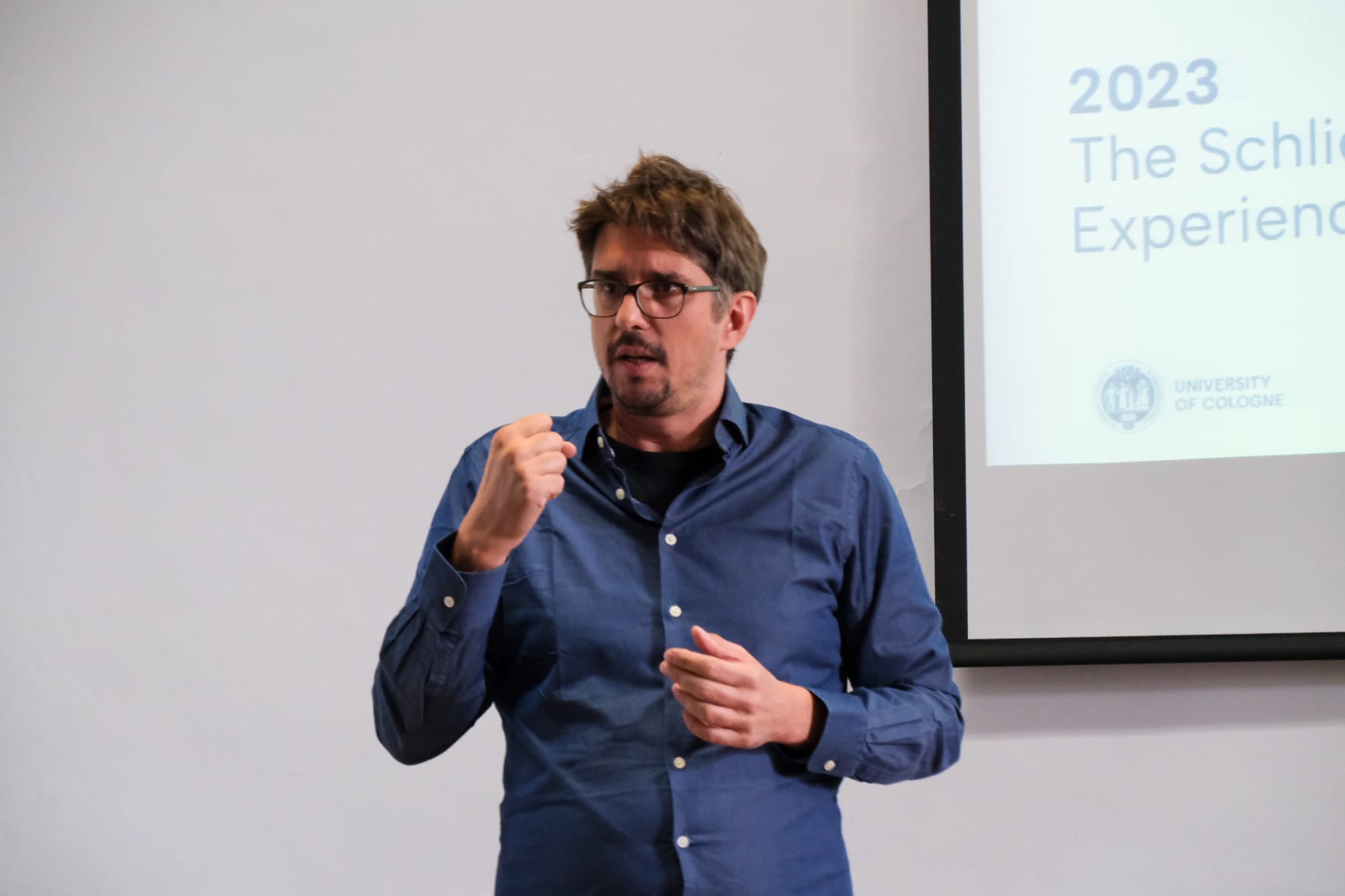 A handsome young(ish) guy giving a presentation to an audience.