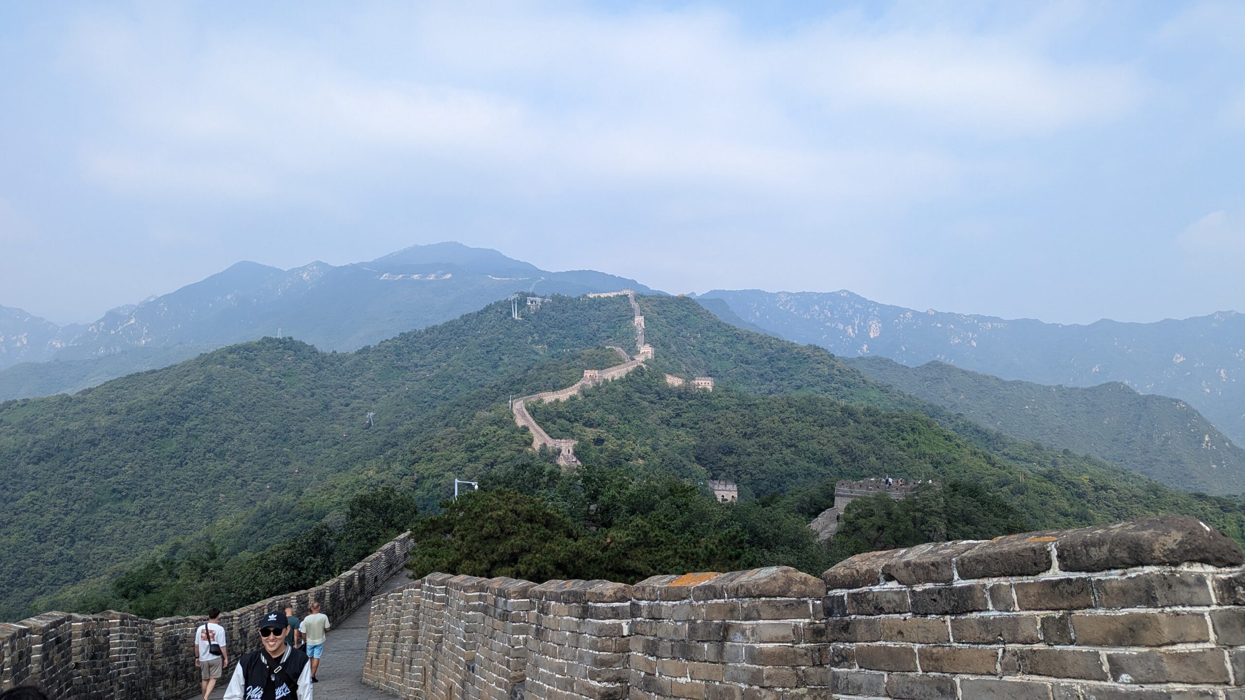 This is a view from the Great Wall of China seeing the length of the wall and how it follows the mountains.